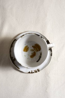 Handmade empty craft ceramic on  textile background.