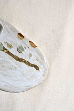 Handmade empty craft ceramic on  textile background.