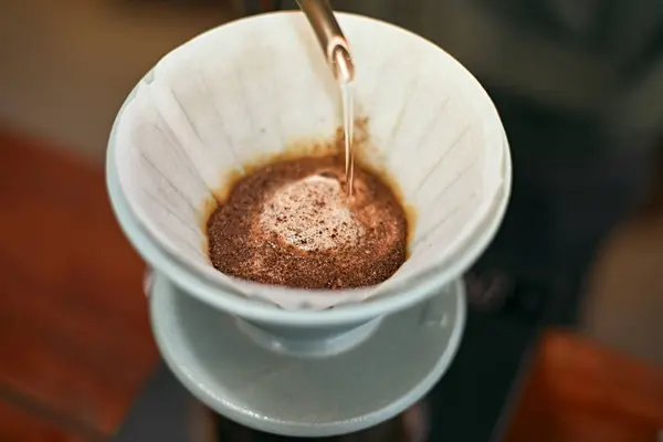 drip coffee, Barista making drip coffee by pouring spills hot wate