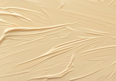 Bej kremin desenli lekeleriyle yapılmış arkaplan.