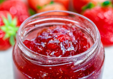 Cam kavanozdaki çilek reçelini taze berrie ile kapat.
