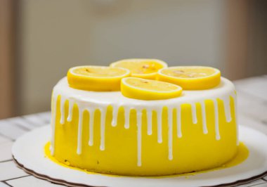 Limon dilimleriyle kaplı limonlu kek, bulanık bir arka grup.