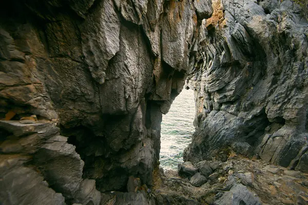 stock image The rock cliff with the blue sea at Tham Phang Beach in Koh Si Chang Chonburi, Thailan