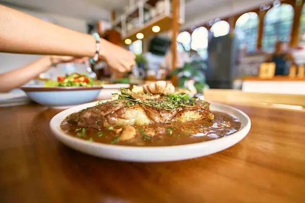 Stock image Striplion steaks with red wine sauce on wooden tabl