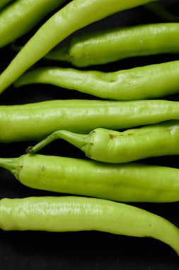 Siyah arka planda taze yeşil biber..