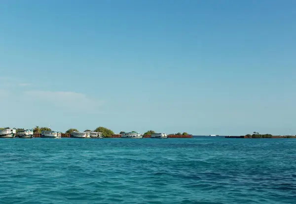 stock image Stunning beachfront boats against a backdrop of clear blue skies and water in Maldives.