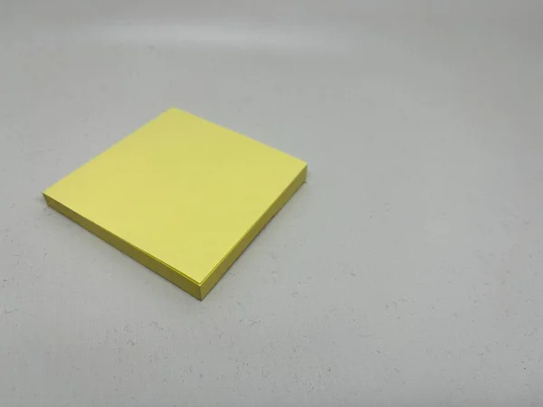 Yellow sticky note block on gray background