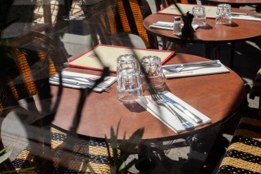 PARIS, FRANCE - APRIL 04, 2023: Table in a Parisian cafe on a sunny day clipart