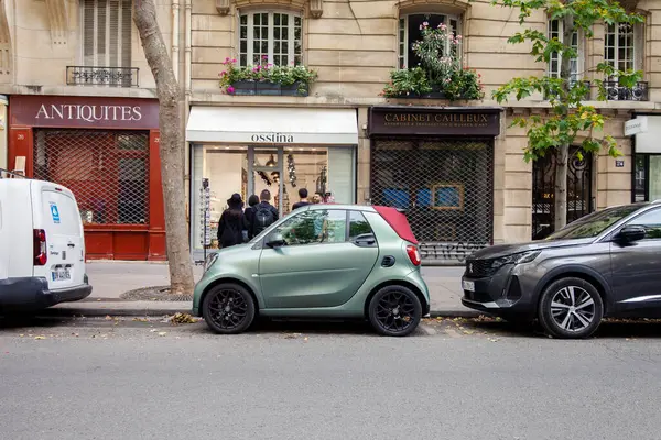 stock image PARIS, FRANCE - JULY 11, 2023: Green color Smart For Two car in Paris