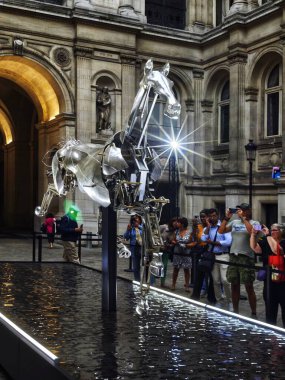 PARIS, FRANCE - September 04, 2024: The aluminum horse that split the water of the Seine during the opening ceremony of the Olympic Games is on public display and free to view in the courtyard of the  clipart