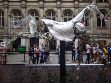 PARIS, FRANCE - September 04, 2024: The aluminum horse that split the water of the Seine during the opening ceremony of the Olympic Games is on public display and free to view in the courtyard of the  clipart