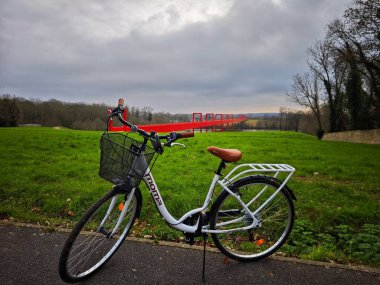 Cergy, FRANCE - December 14, 2024: Bike ride at Ax Majeur in Cergy - an iconic public art piece created by artist Dani Caravan. clipart