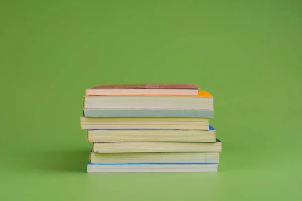 Books. Stack of books stacked on light green background. Reading. Reading concept. and collection of books