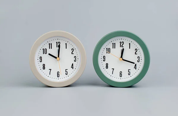 Alarm clock on gray scene, time concept operation of time When it\'s important to work and live