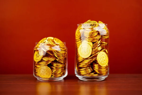 gold coins in a glass jar saving money coin coin bank income wages expenditure money financial stability
