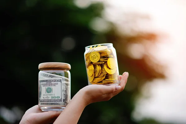 gold coins in a glass jar gold savings concept finance banking financial planning financial stability