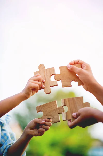 jigsaw in hand puzzle pieces gather together teamwork The concept of planning work as a team.