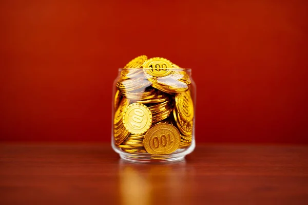 gold in glass jar gold savings in glass jar valuable assets Financial loans and investments. Gold stocks. Gold market. Gold concept and gold accumulation.