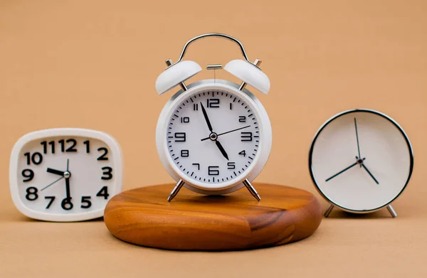 Alarm clock placed on a wooden stand, time work concept the value of limited time Appointments and punctuality at work