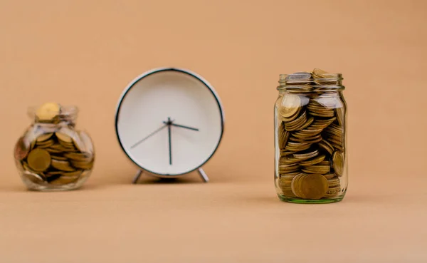 money and time saving money in a glass jar Saving money creates the future. Investment savings. Income. Investment. Cash flow. Coins. Money saving and financial investment concept. accumulation of financial assets