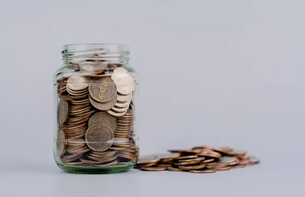 Money coins. Saving coins in a glass jar. Coin bank, finance and financial investment Cash loans, cash flow, wages, income, budget, financial support, financial wealth