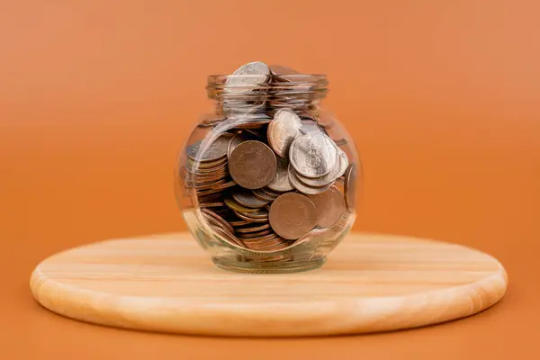 Money coins. Saving coins in a glass jar. Coin bank, finance and financial investment Cash loans, cash flow, wages, income, budget, financial support, financial wealth