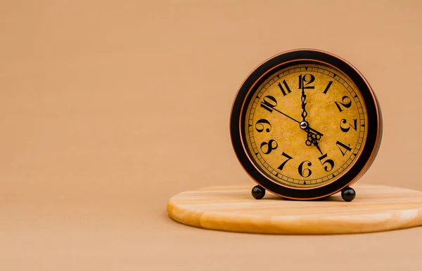Brown vintage alarm clock Photo of a stationary clock, concept of time and how time works.