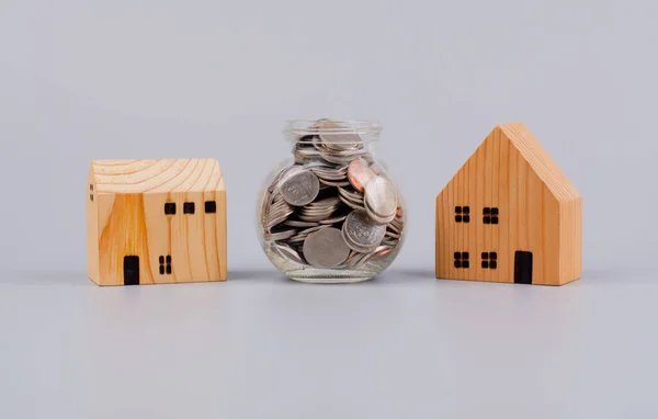 Coins and houses Saving money to build a house Home loans and cash, cash flow, assets and real estate, investments