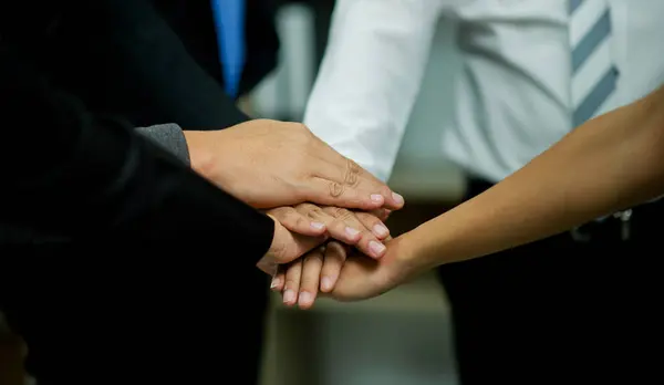 Hands together, teamwork, cooperation and unity in work and success in work.