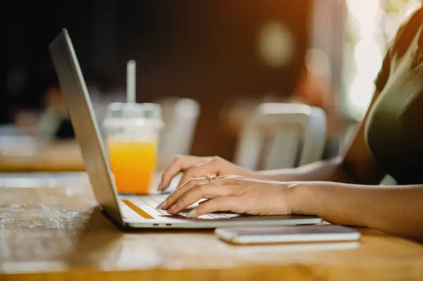 stock image Typing on a laptop, working in a coffee shop, freelancing and independent work