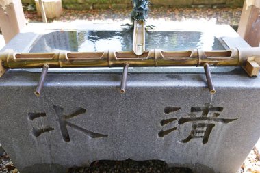 The purification fountain 'Chozuya' in the Japanese shrine. It's place where you wash your hands and rinseyour mouth at a shrine. This is a ritual cleansing.