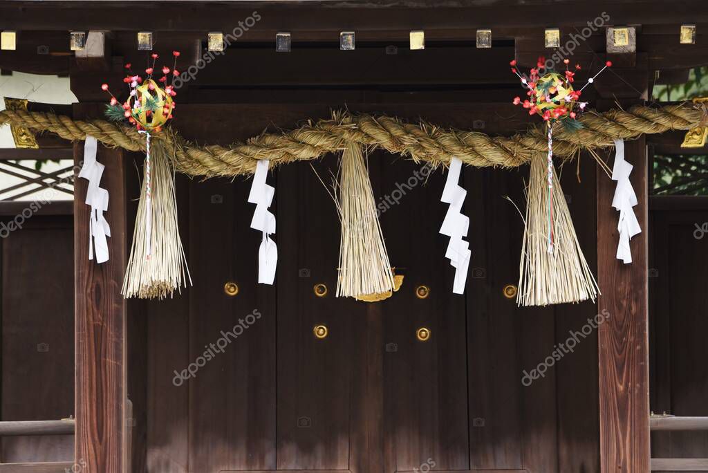 'Shimenawa' ( Shinto straw festoon ) in the japanese shrine. Shimenawa consists of a ricestraw