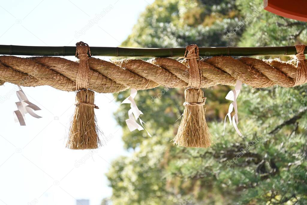 'Shimenawa' ( Shinto straw festoon ) in the japanese shrine. Shimenawa consists of a ricestraw