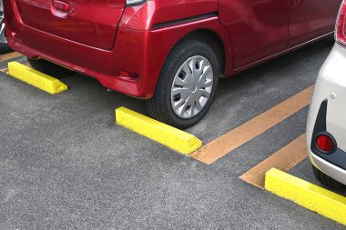 A scene of a paid parking lot for cars in Japan. The parking lot's automatic gate system. clipart