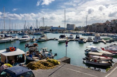 Parga's sightseeing train under an old and big plane tree at Louka's stone watermill in Anthousa's village gorge. The watermill nowadays is a folkrore museum