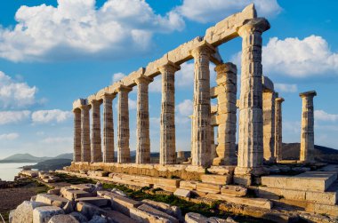 Sounion, Attica - Greece. The Temple of Poseidon at cape Sounion.. Early morning time, cloudy blue sky