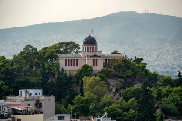 The National Observatory of Athens city, Greece on top of the Nymphs\' Hill in Thission district. View from Plaka district under the Acropolis of Athens. Sunny day, Athens city in the background