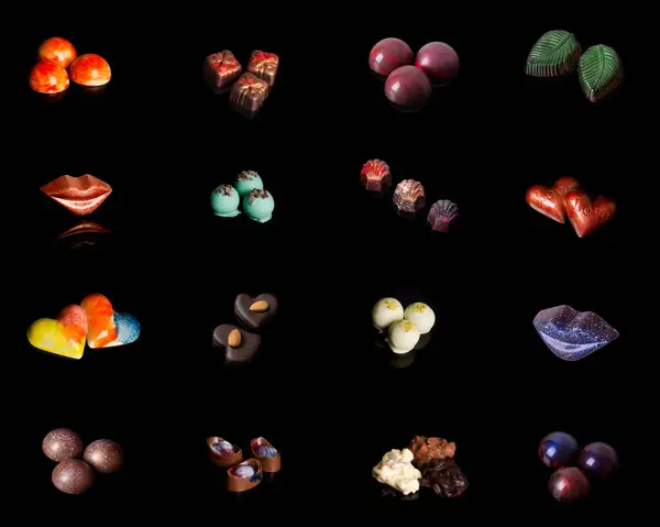 Gurme el yapımı Belçika çikolatalı bonbonları siyah arka planda izole edilmiş..