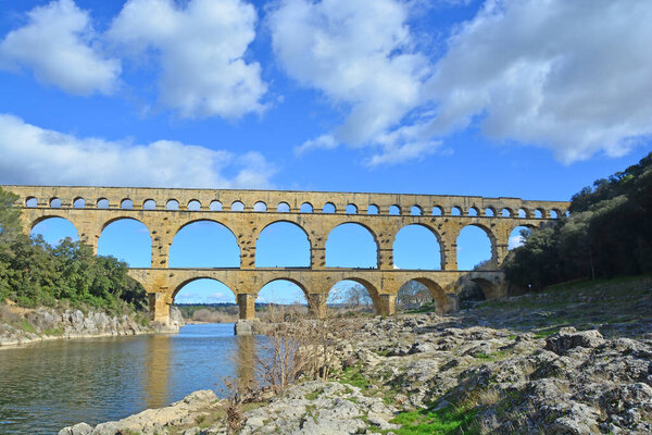 The Ancient Roman Pont du Gard aqueduct and viaduct bridge over the River Gardon, the highest of all ancient roman bridges, near to Nimes in the South of France
