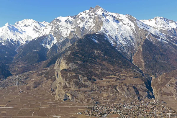 Güney İsviçre Alplerinde, Rhone Vadisi 'nin yukarısındaki Haut du Cry ve üzüm bağlarıyla Ardon köyü. Kışın çekildi.