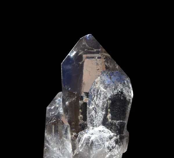 A piece of clear quartz found on the Mt Blanc in France, known as smokey quartz. Isolated against a black background.