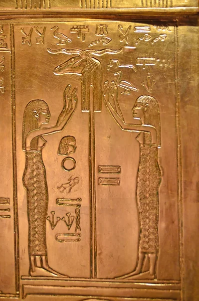 Two women worshiping the symbol of the ancient Egyptian God Khnum, the divine potter and creator of humanity, also the God of the River Nile, Engraving on a gold sheet