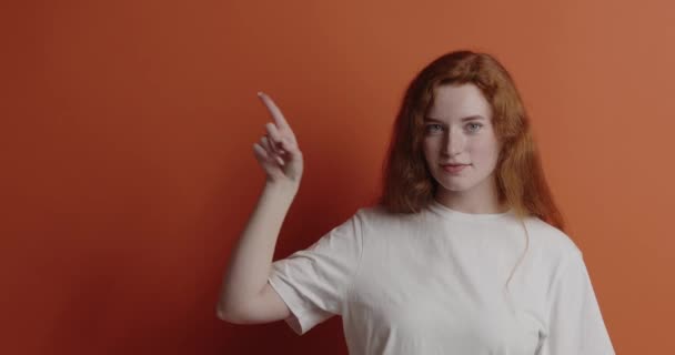 Cheerful Woman Pointing Studio Overjoyed Ginger Girl Points Finger Empty — Stock Video