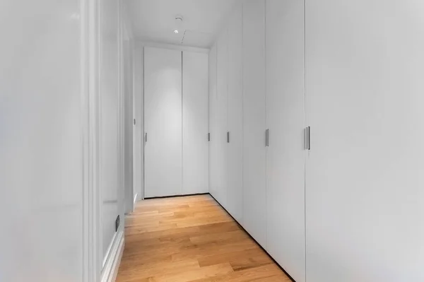 many white wardrobes in the closet room