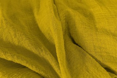 Sarı renkli kumaş yüzeylerin yakın çekimi