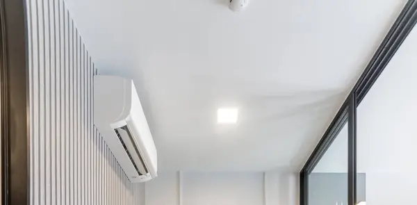 White Wall-Mounted Air Conditioner in a Pristine White Room