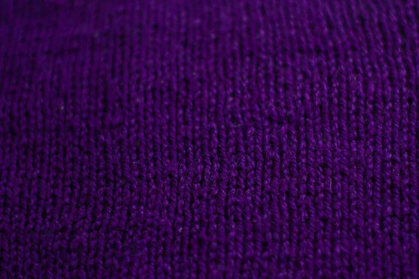 stock image Knitted sweater with small braid, plain purple background.