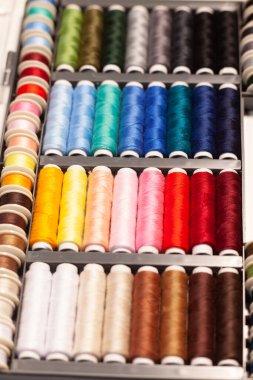 Birçok renkli dikiş iplikleri makaraların üzerine
