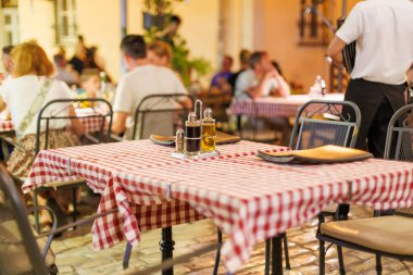 Sıcak bir yaz akşamı kalabalık bir restoranda boş bir masa.