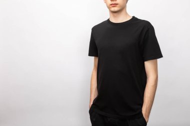 Young skinny teenager wearing blank black shortsleeve cotton T-Shirt